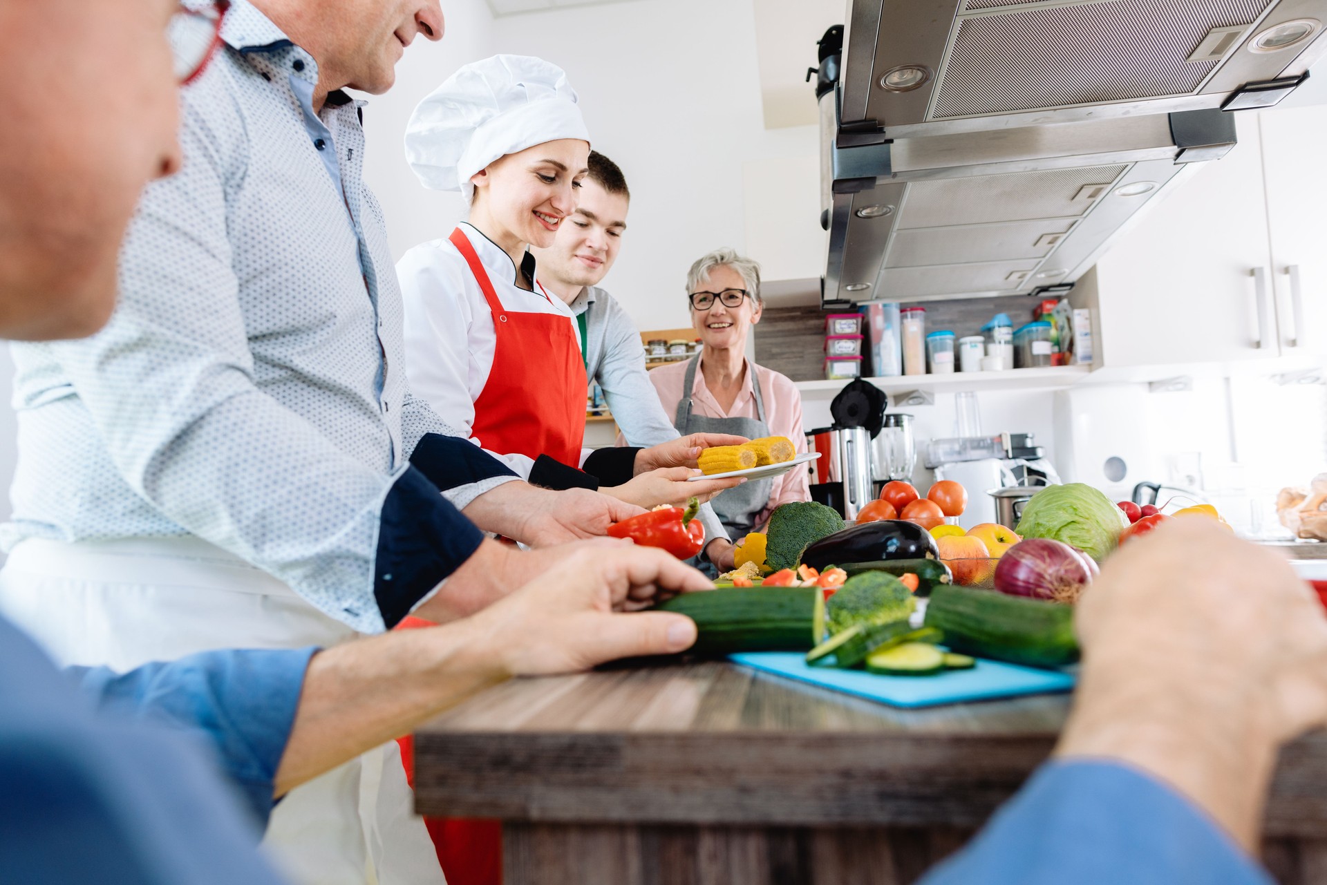 People learning healthy cooking in a training kitchen